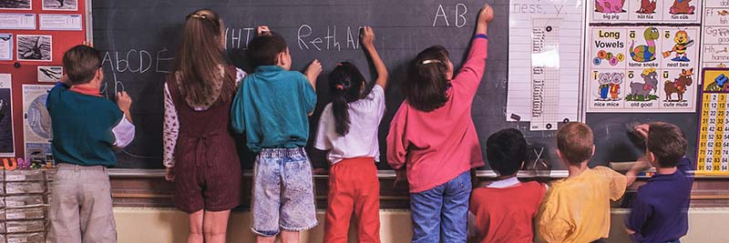 Children at school at blackboard